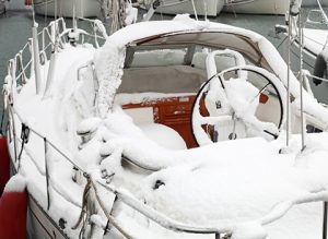 boat with snow in harbor